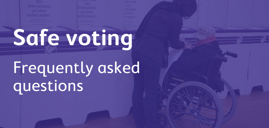 A woman in a wheelchair gets help to vote at a voting centre